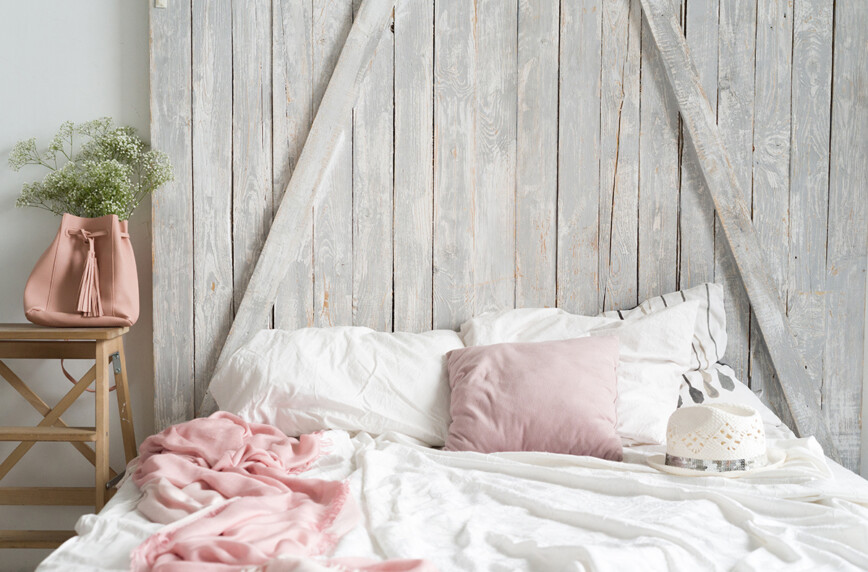 Light airy bedroom. Distressed wiid and pastel colours