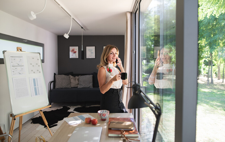 Women working in garden room office