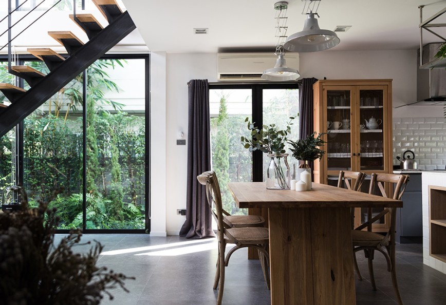 Modern designed building with country/rustic kitchen. Windows dressed with black curtains